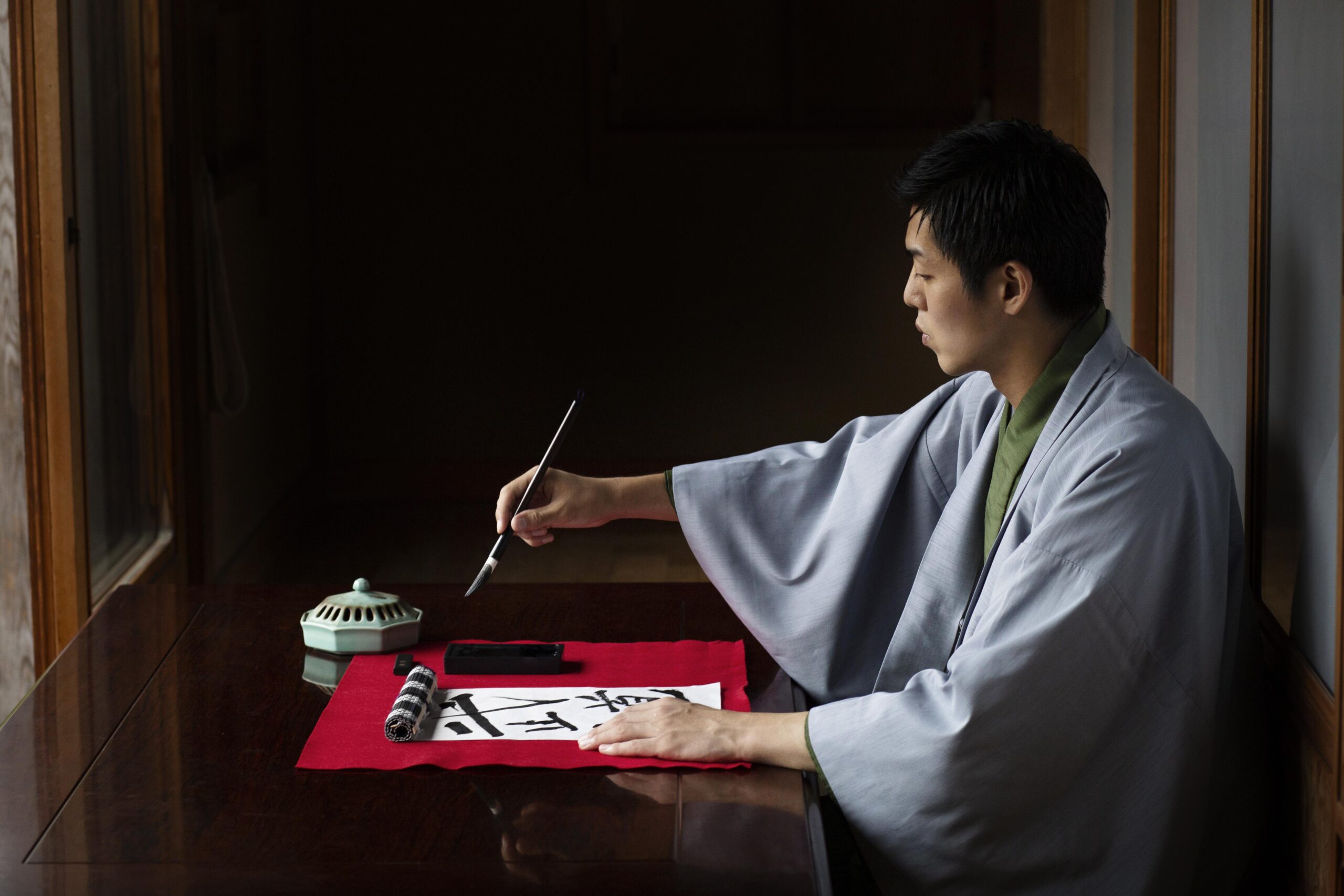 man-practicing-japanese-handwriting